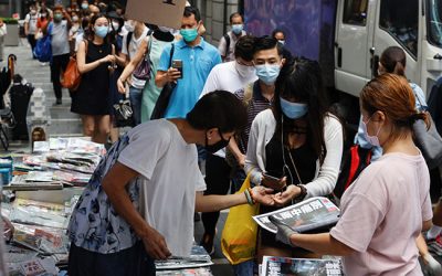 People queue to buy copies of the final edition of Apple Daily, published by Next Digital, in the Central financial district, in Hong Kong