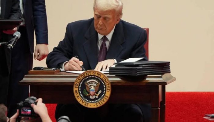 trump signing papers